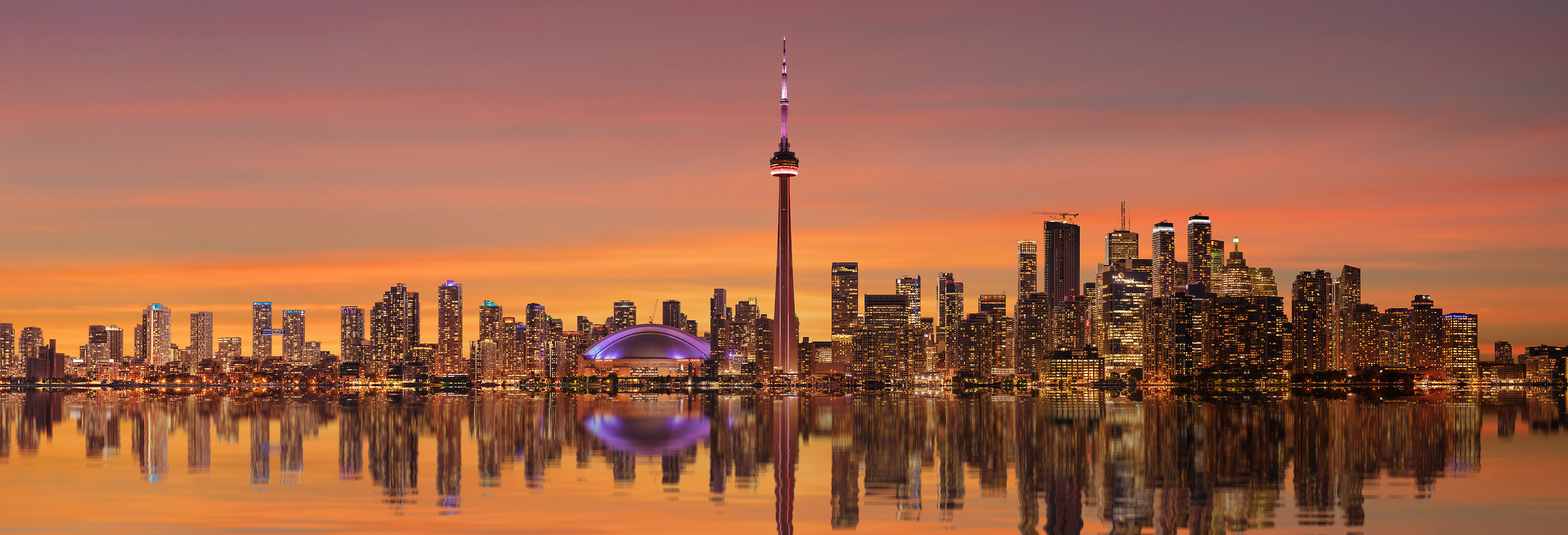 A very high resolution, large-format VAST photo print of the Toronto skyline at sunset with a reflection in Lake Ontario; cityscape photograph created by Chris Collacott in Toronto, Ontario, Canada.